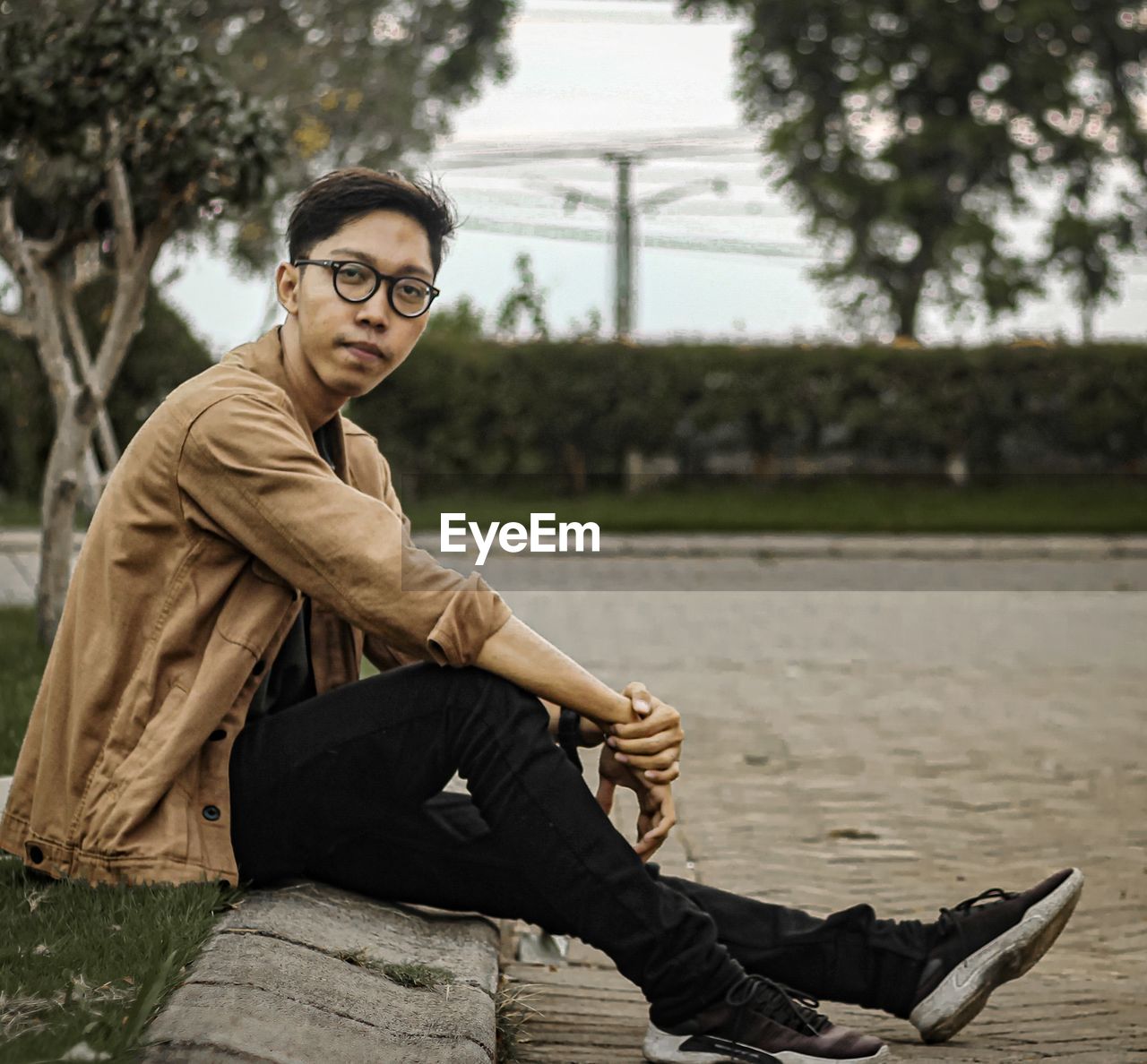 Portrait of young men sitting outdoors