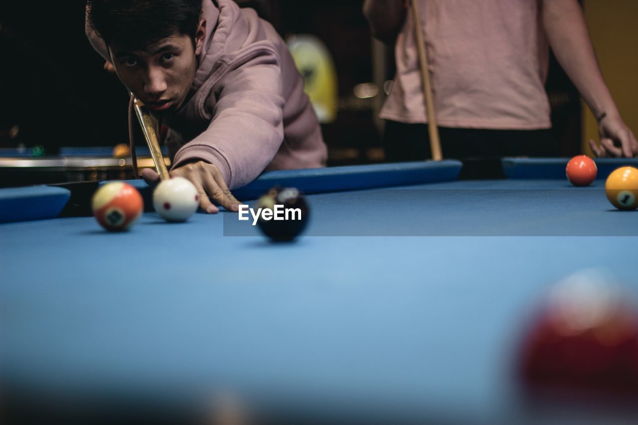 Portrait of boy playing pool