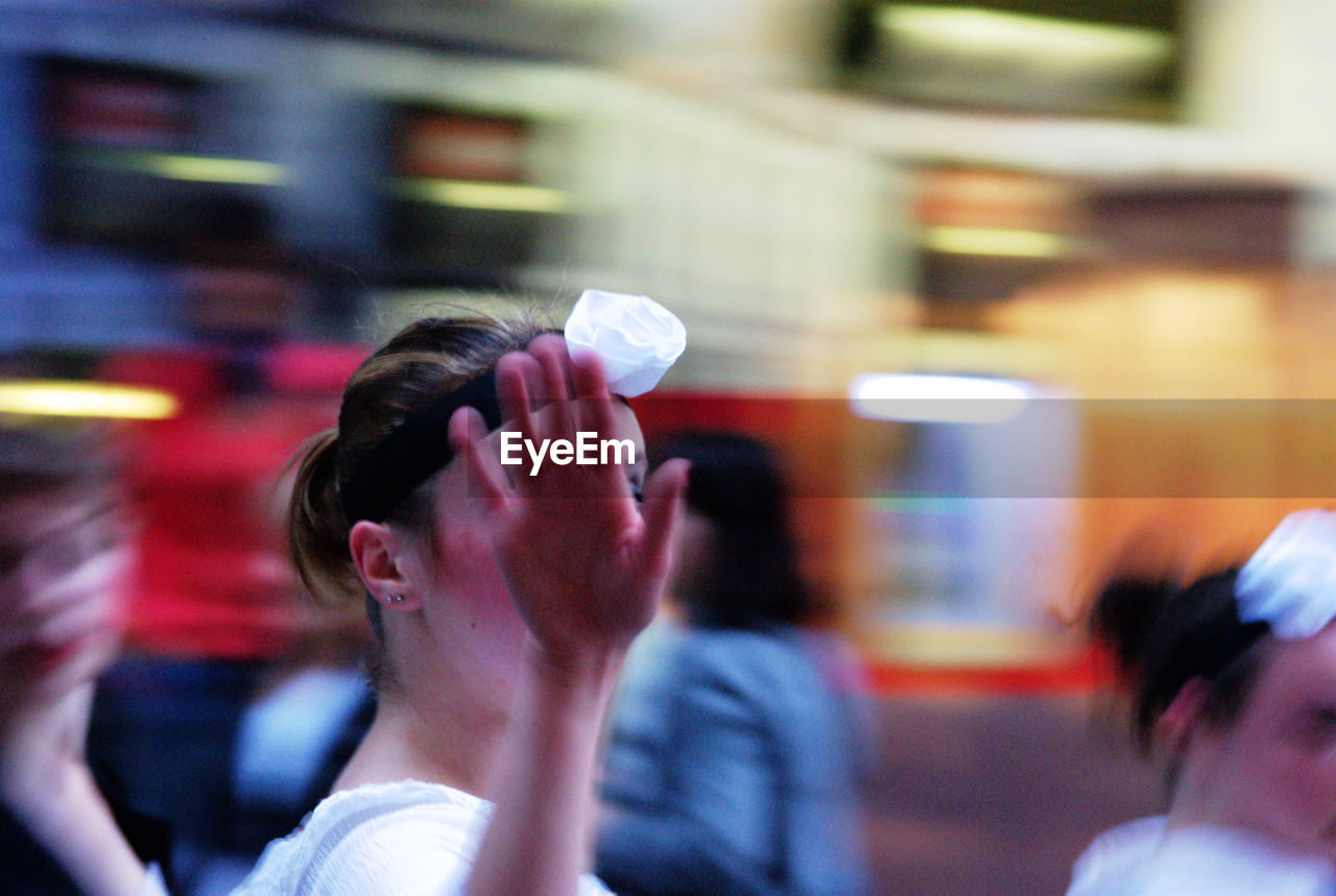 Close-up of woman waving