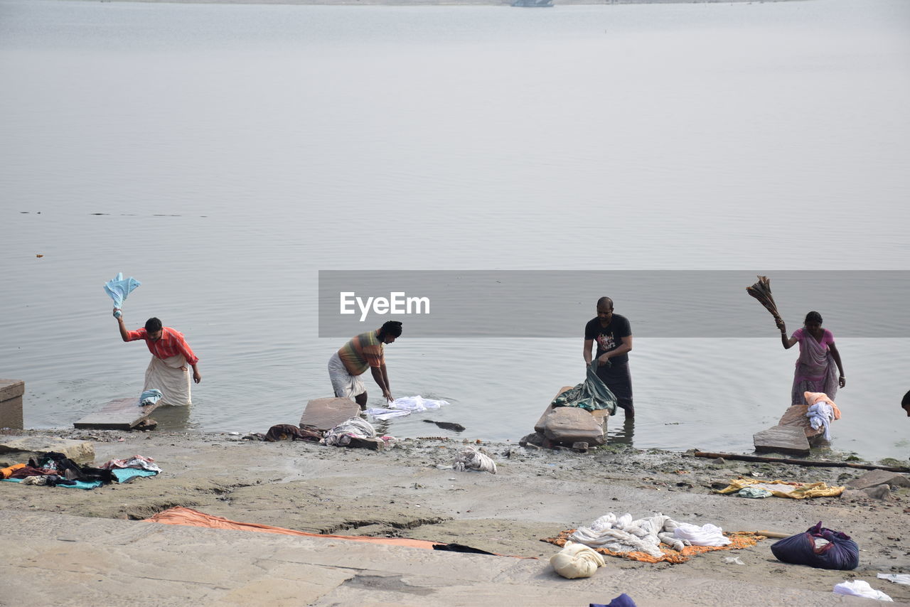 PEOPLE WORKING ON BEACH