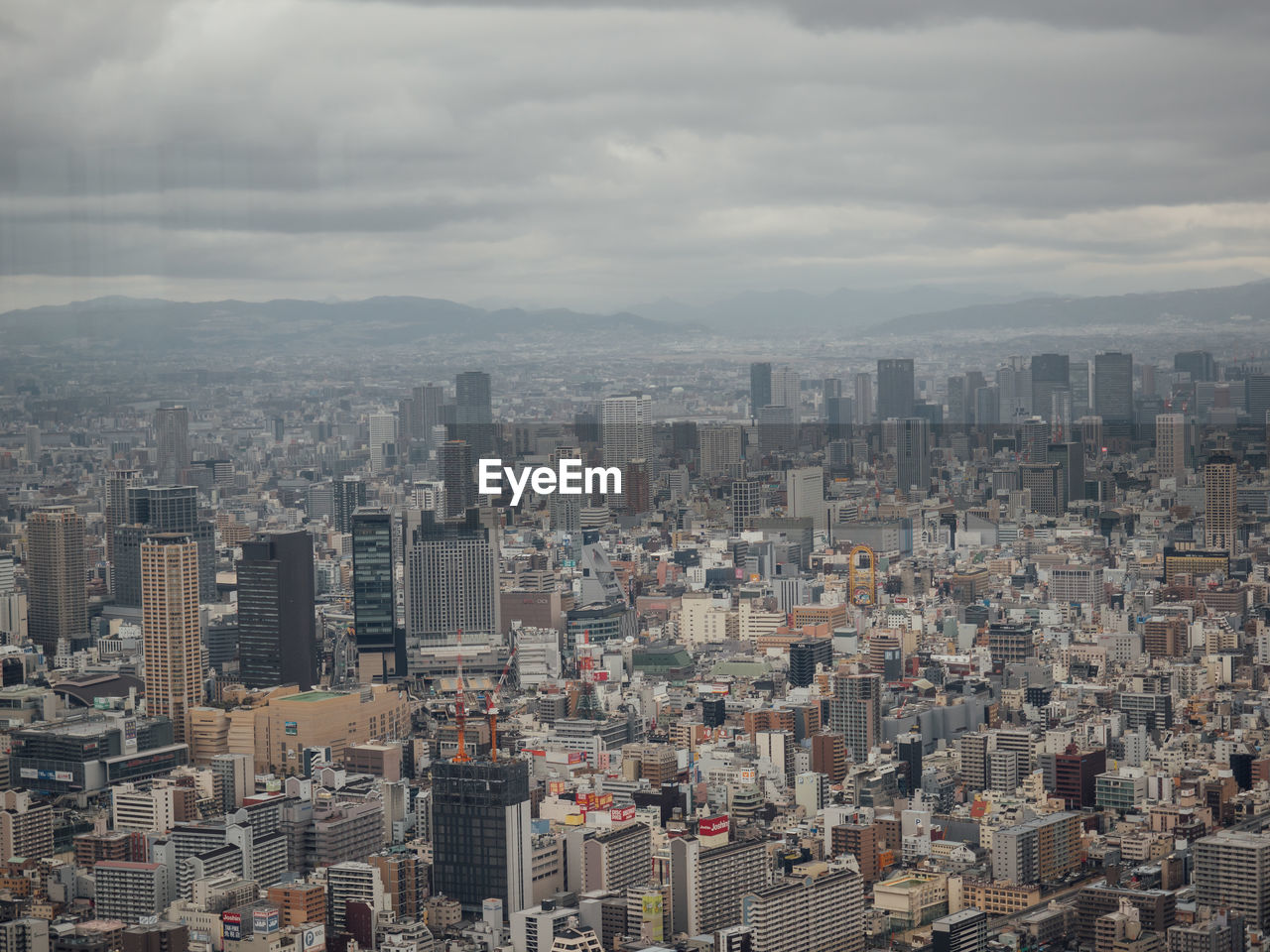 Aerial view of buildings in city against sky