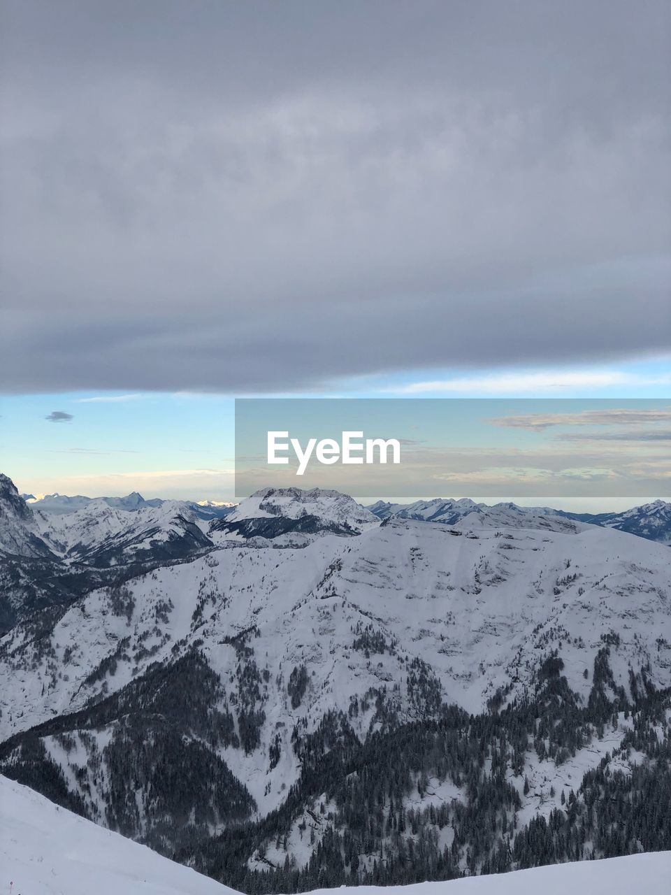 Scenic view of snow covered mountains against sky