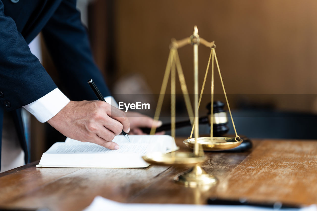 midsection of businessman working at table