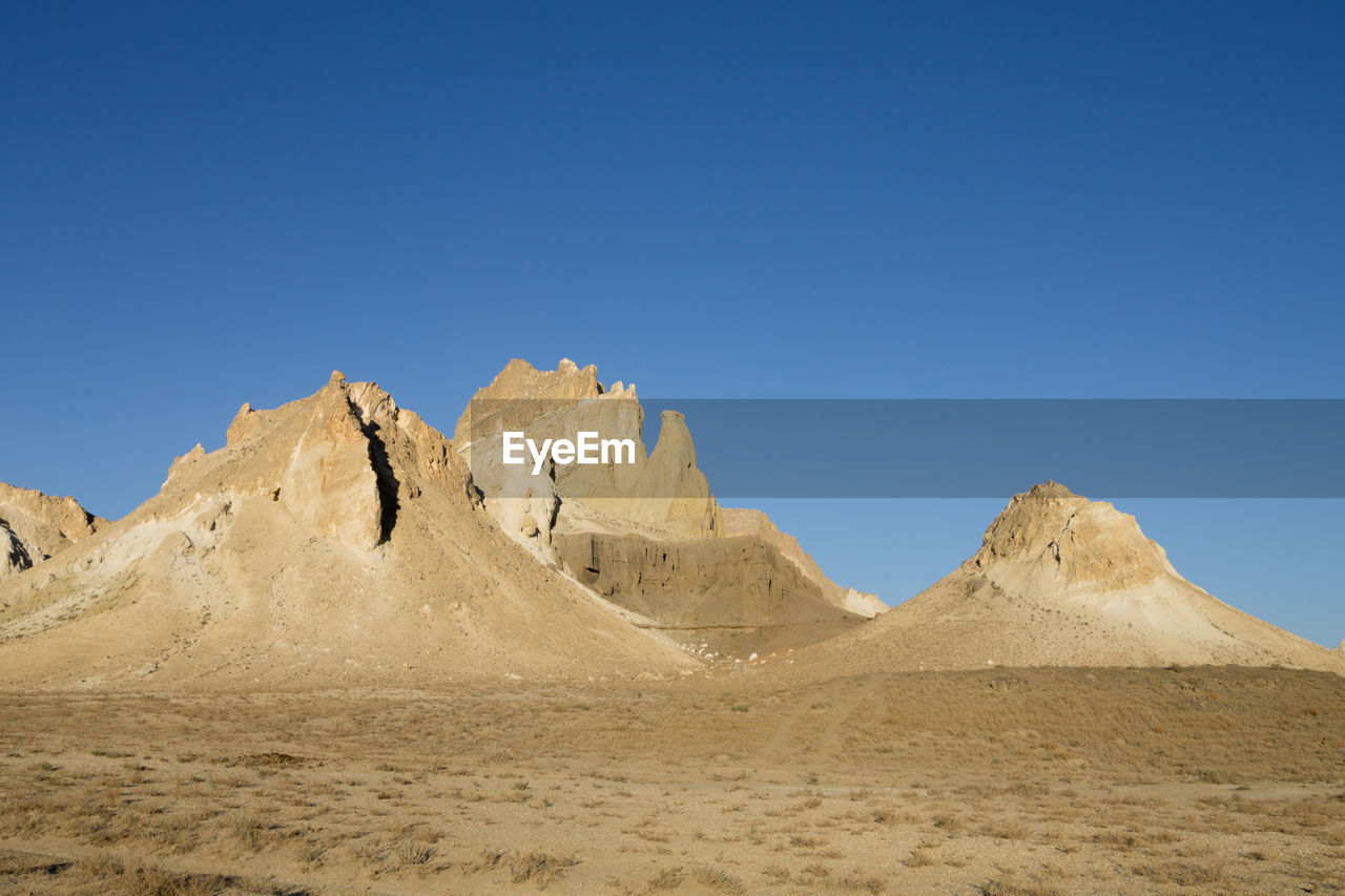 scenic view of desert against clear sky