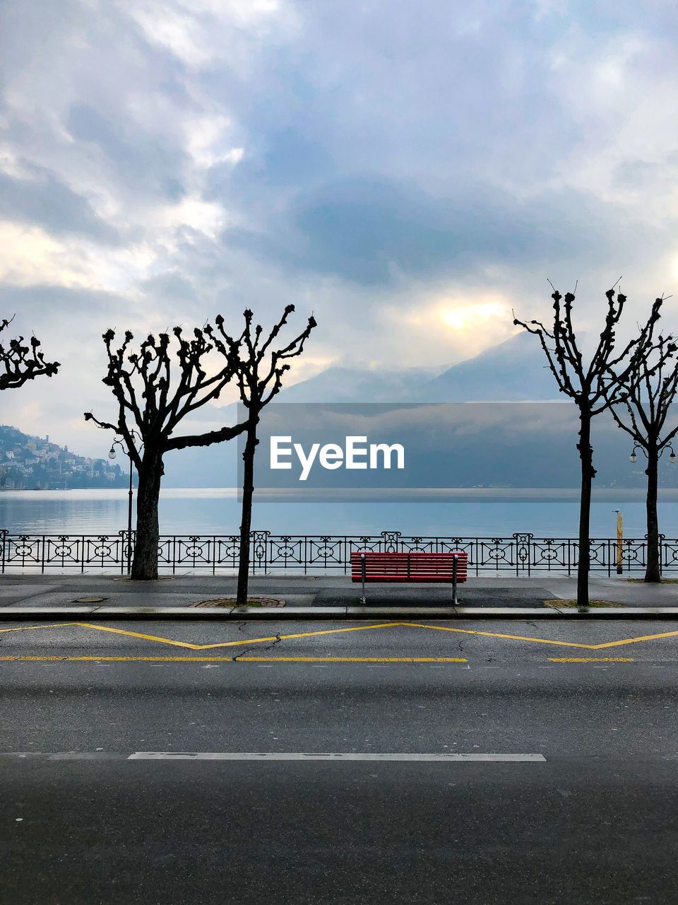 Road by sea against sky in city