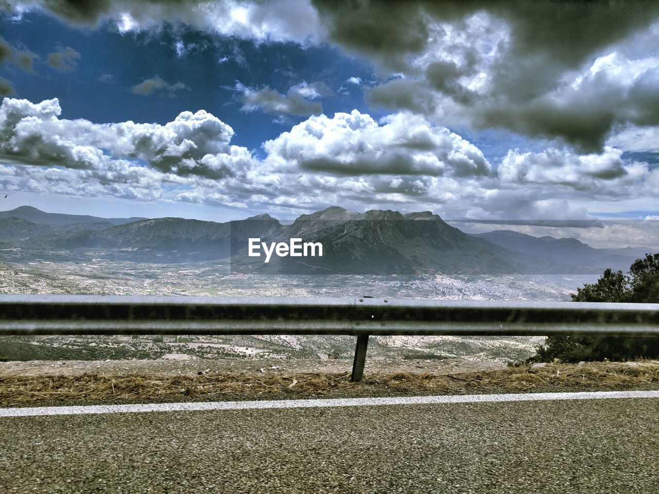 SCENIC VIEW OF LANDSCAPE BY MOUNTAINS AGAINST SKY