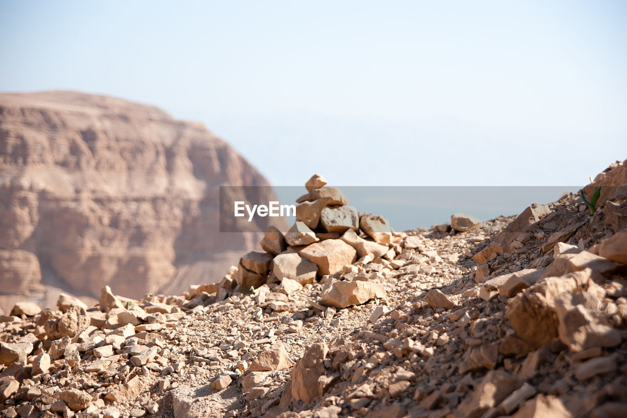 SURFACE LEVEL OF ROCKS AGAINST SKY