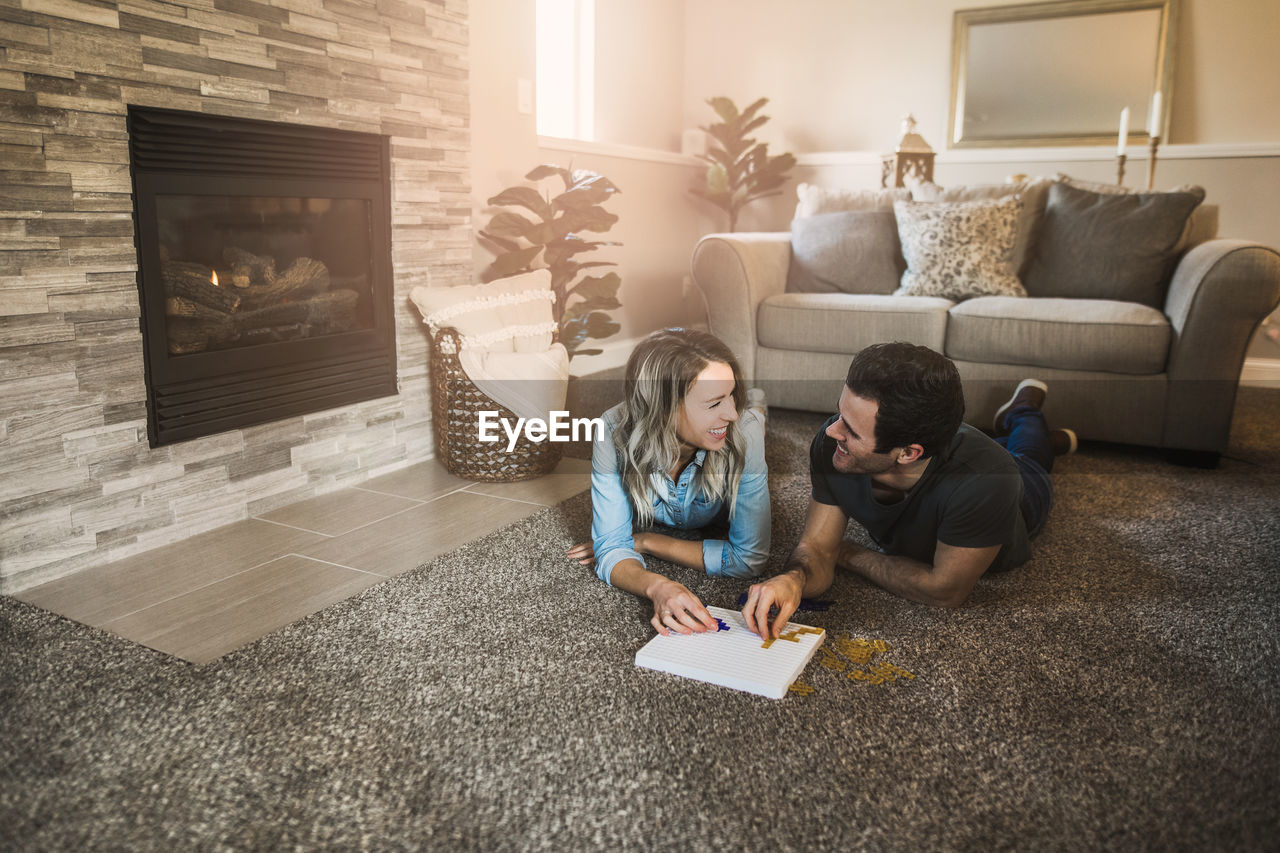 HIGH ANGLE VIEW OF PEOPLE SITTING ON SOFA