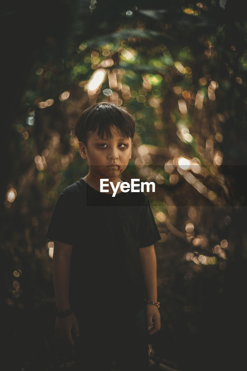 Portrait of boy standing outdoors