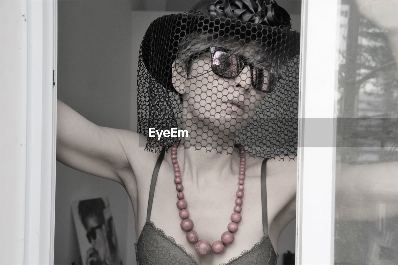 Close-up of woman wearing hat with veil