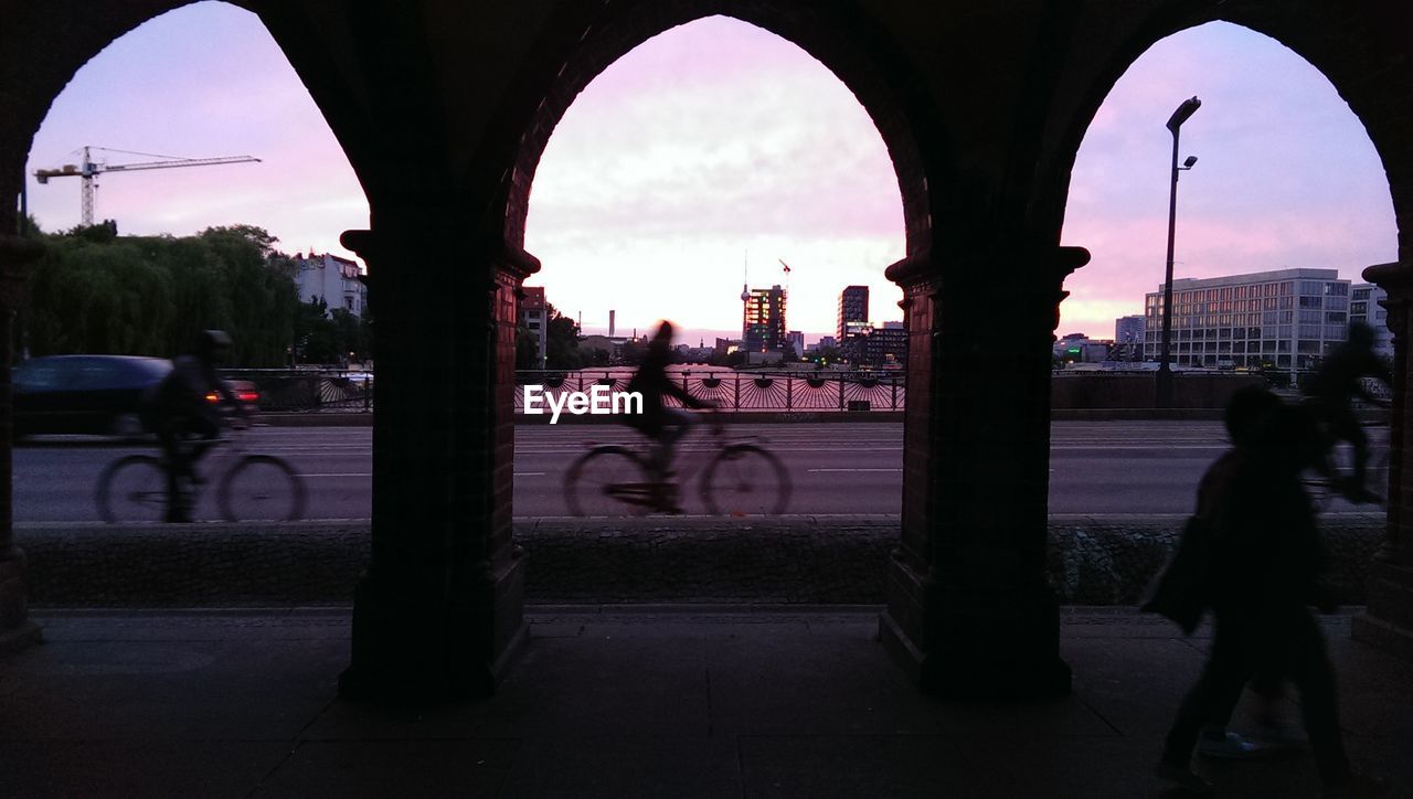 City street against sky at sunset