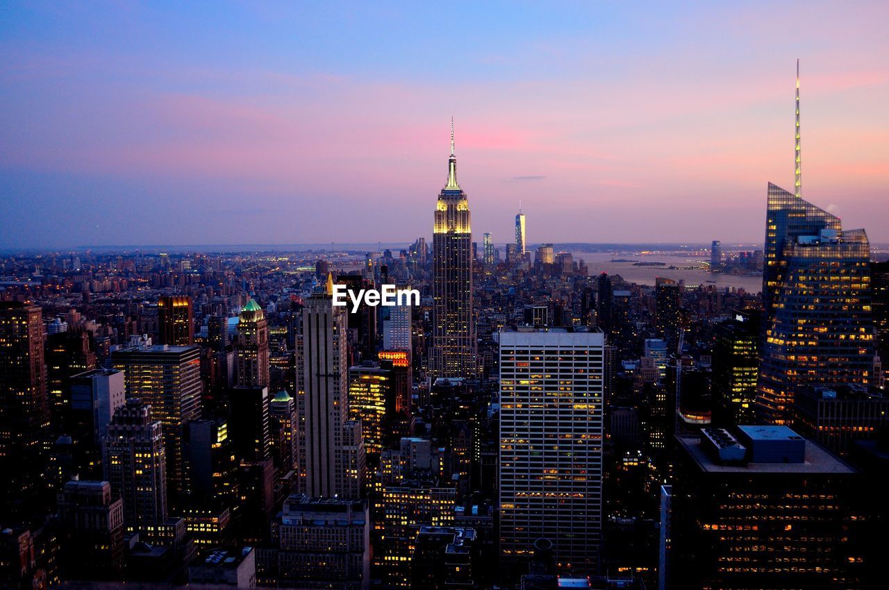 Skyscrapers in city at dusk