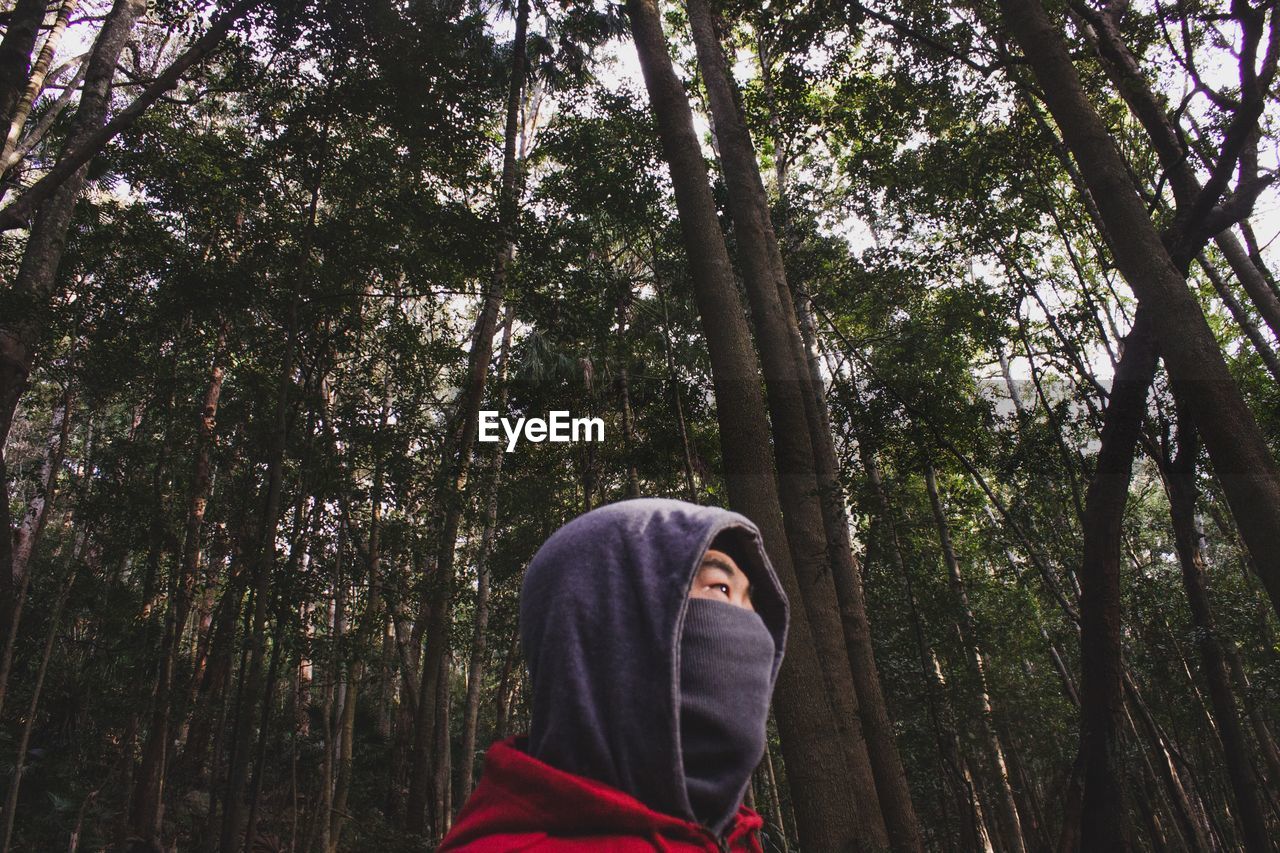 WOMAN STANDING IN FOREST