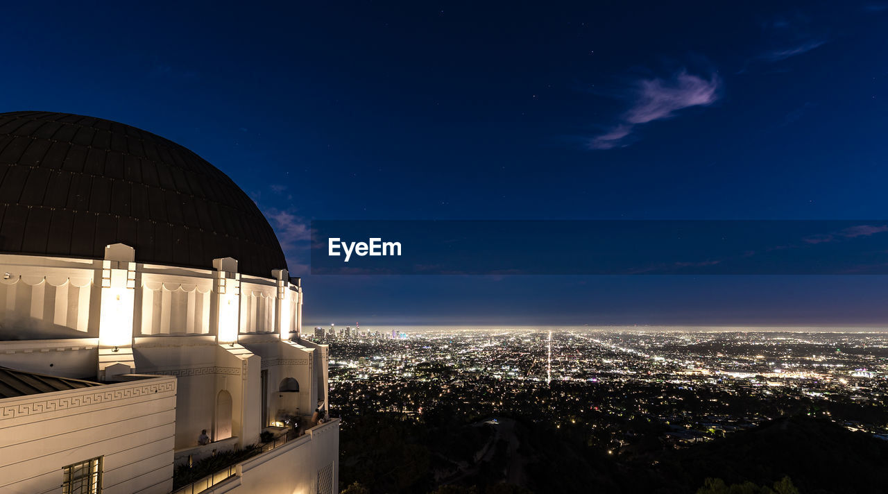 The griffith park observatory sits high in the hills overlooking los angeles.