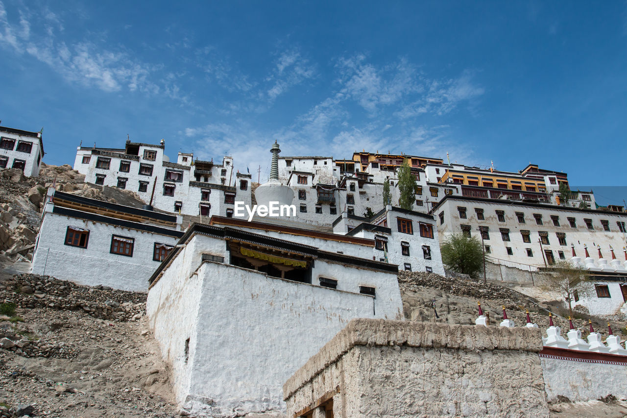 Low angle view of buildings against blue sky