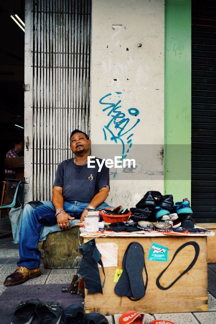 FULL LENGTH OF MAN WORKING AGAINST BLUE SKY