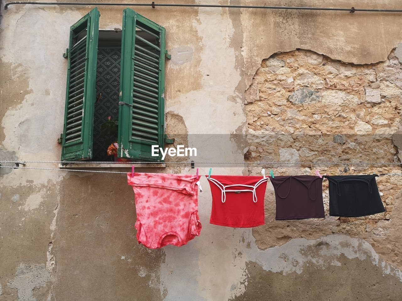 Clothes drying against wall of old building