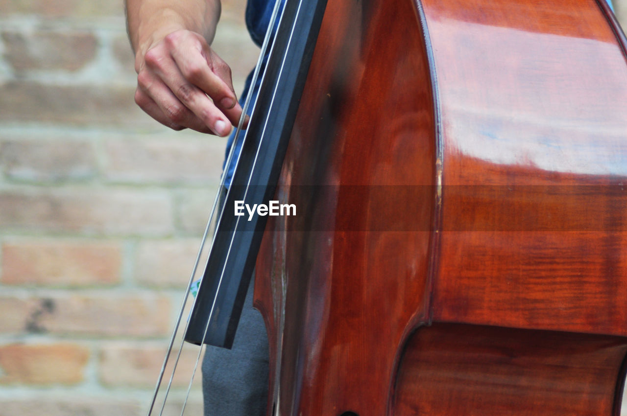 Midsection of person playing cello