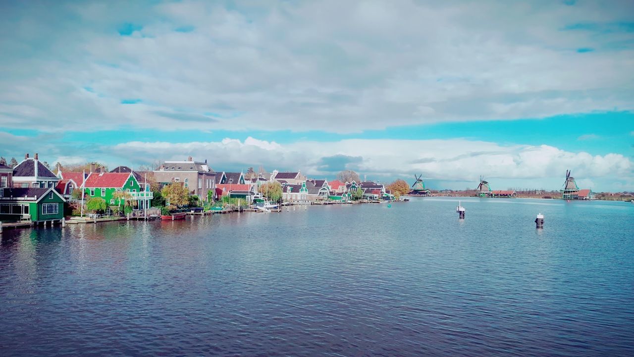 Panoramic view of sea and buildings against sky