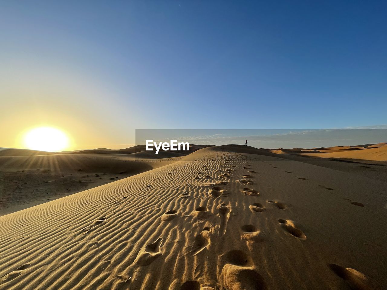 Scenic view of sahara dunes against clear sky during sunset