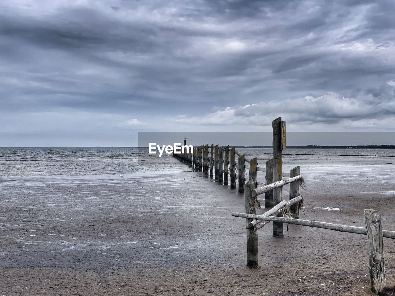 Wooden pier on sea against sky