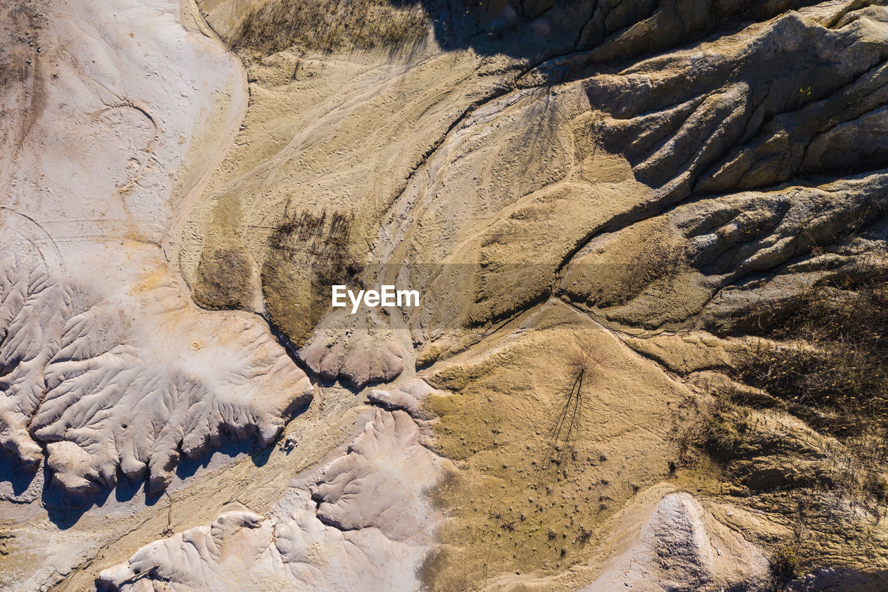 Surrealistic aerial image of abandoned opencast mine. bad land pattern and lake from a drone