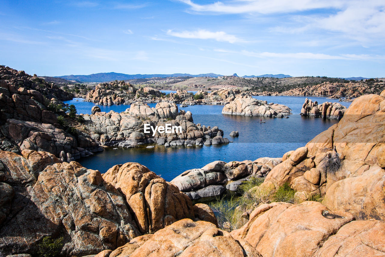 Panoramic view of sea by cliff against sky