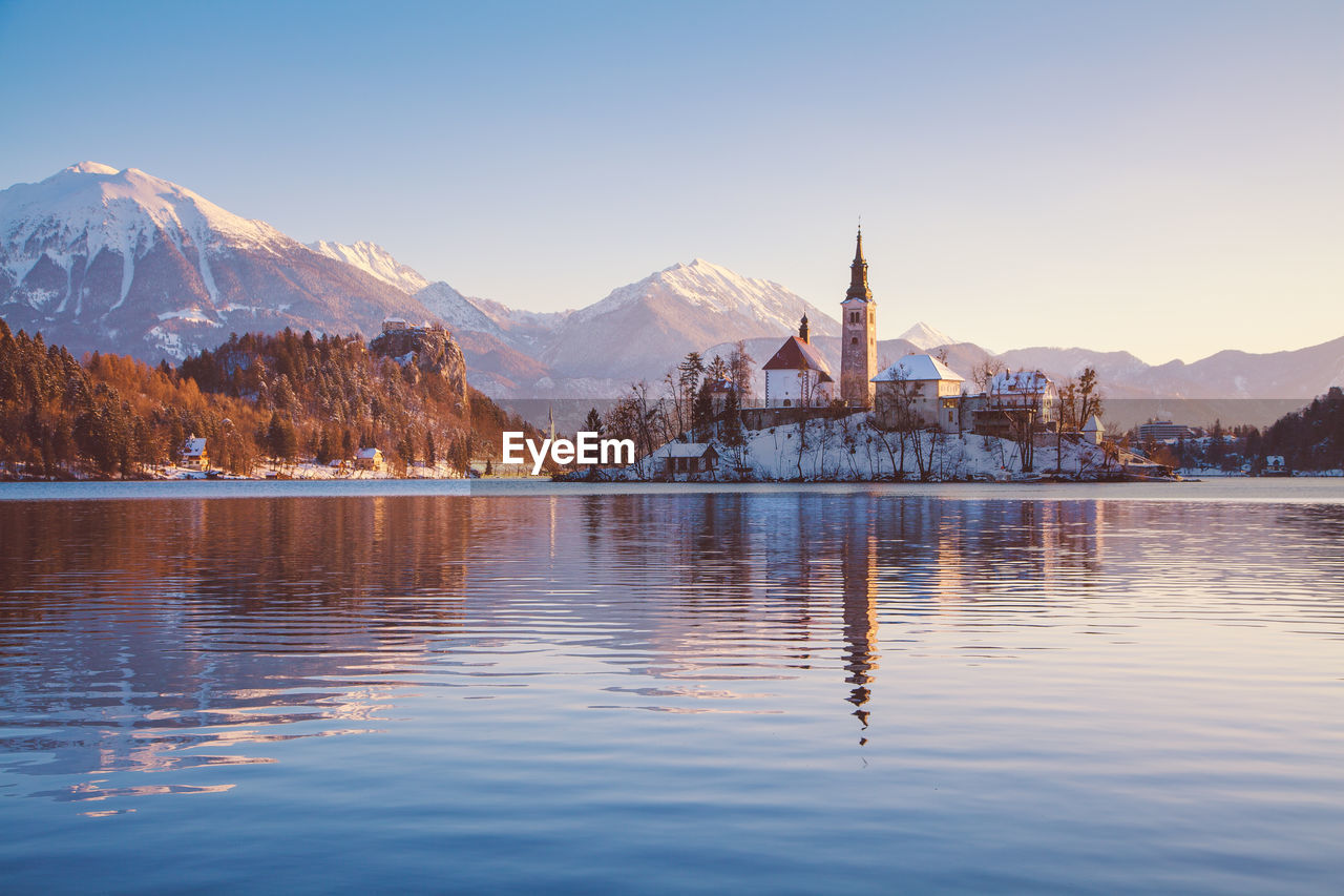 SCENIC VIEW OF LAKE BY BUILDING AGAINST SKY DURING WINTER