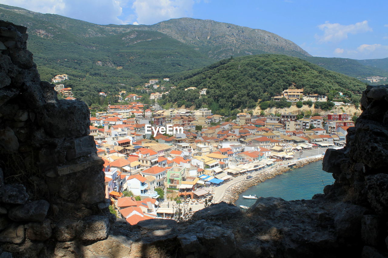 High angle view of town against forest mountain