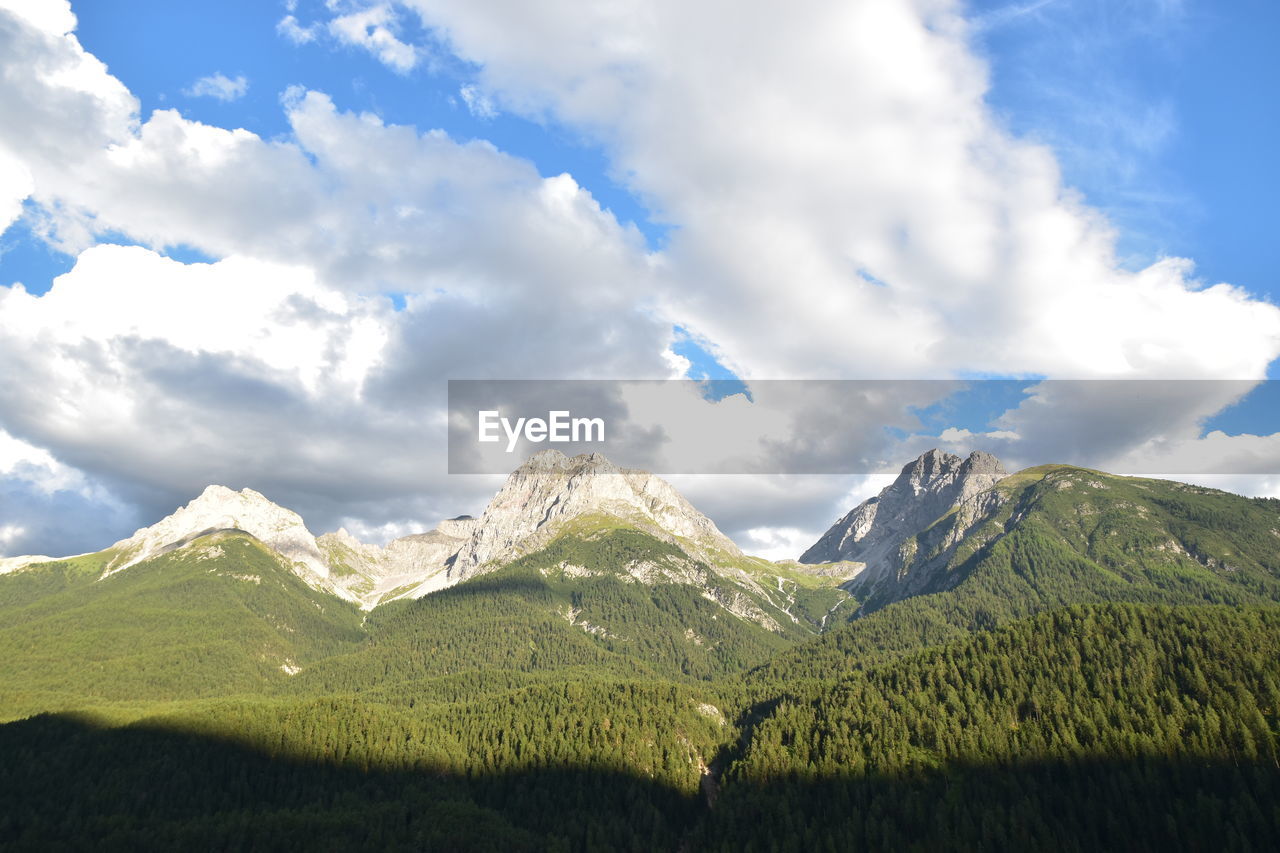 Scenic view of mountains against cloudy sky