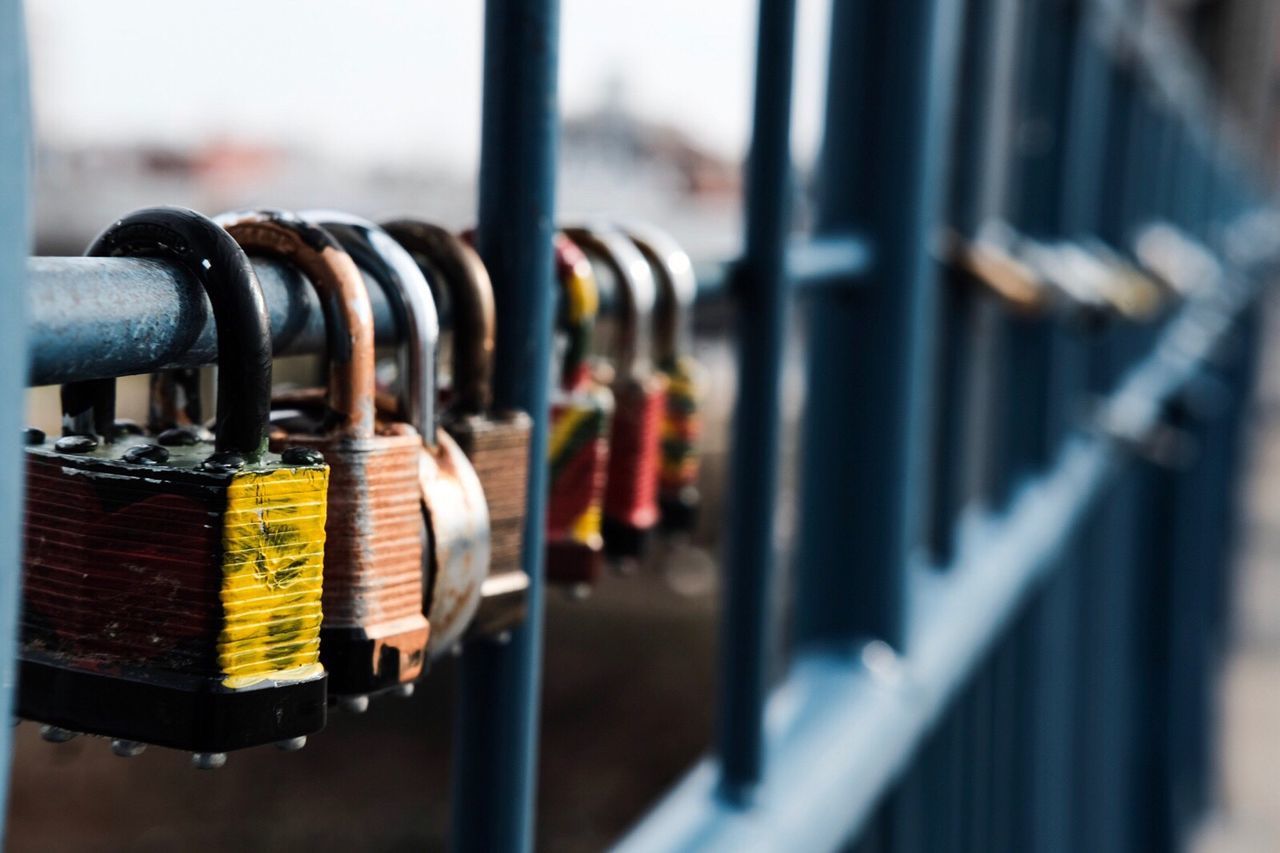 Close-up of padlocks on fence