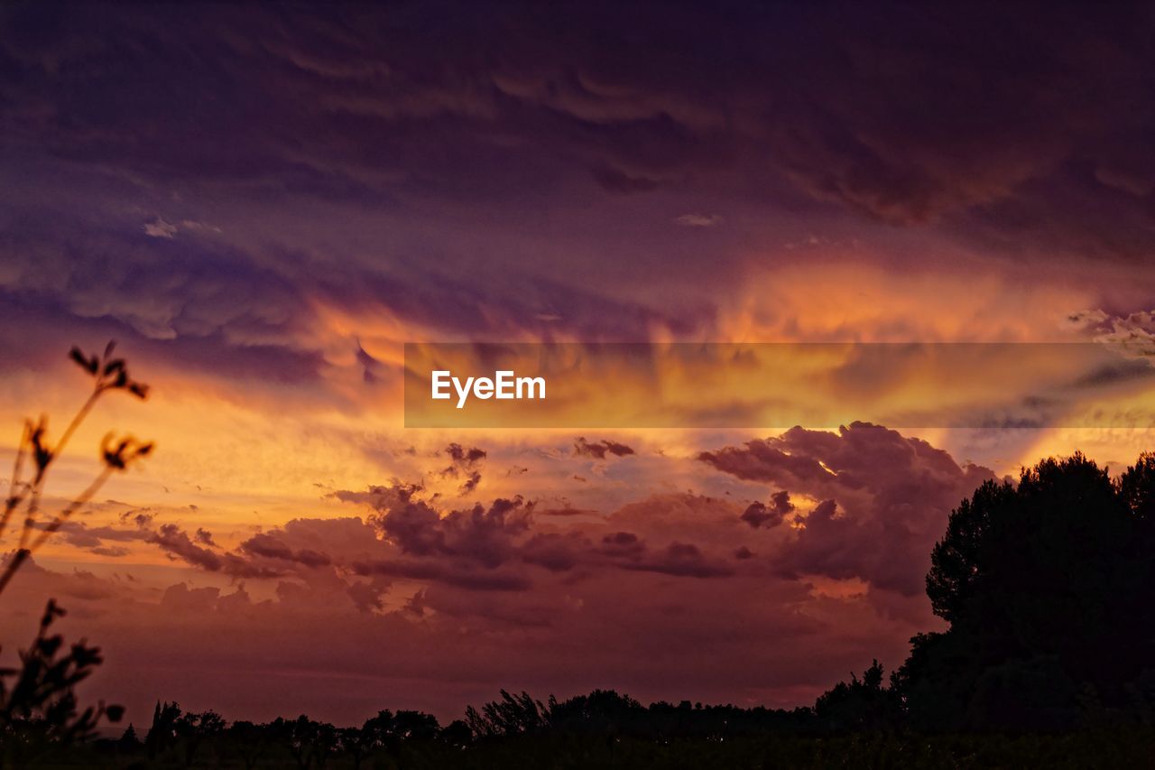 SCENIC VIEW OF DRAMATIC SKY DURING SUNSET