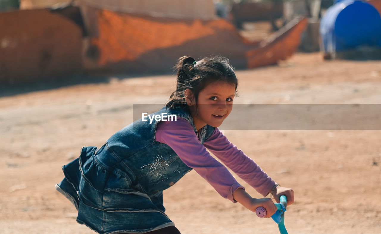 A cute little girl in a syrian refugee camp. the spread of cholera in refugee camps.