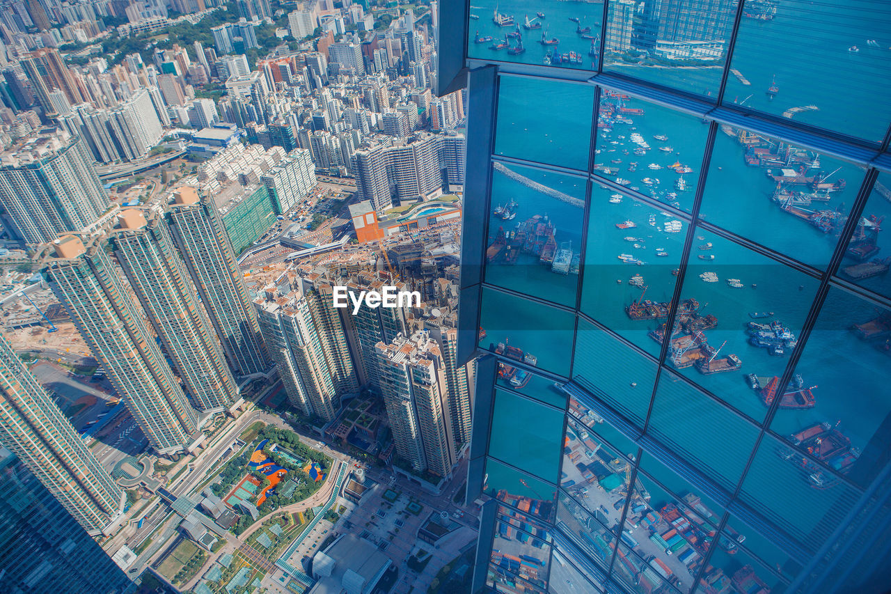 Reflection of victoria harbour on modern building in city