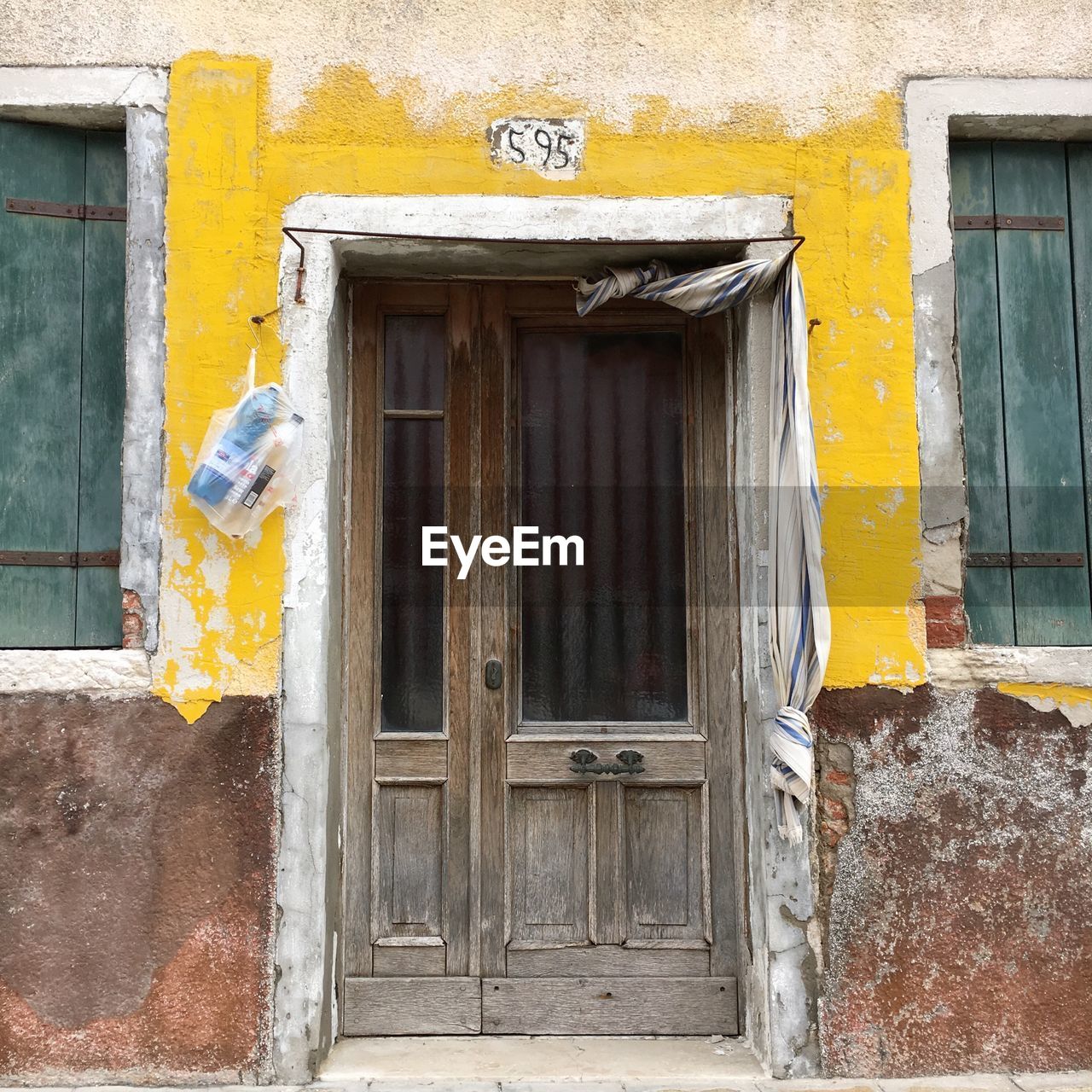 CLOSED DOOR OF YELLOW HOUSE