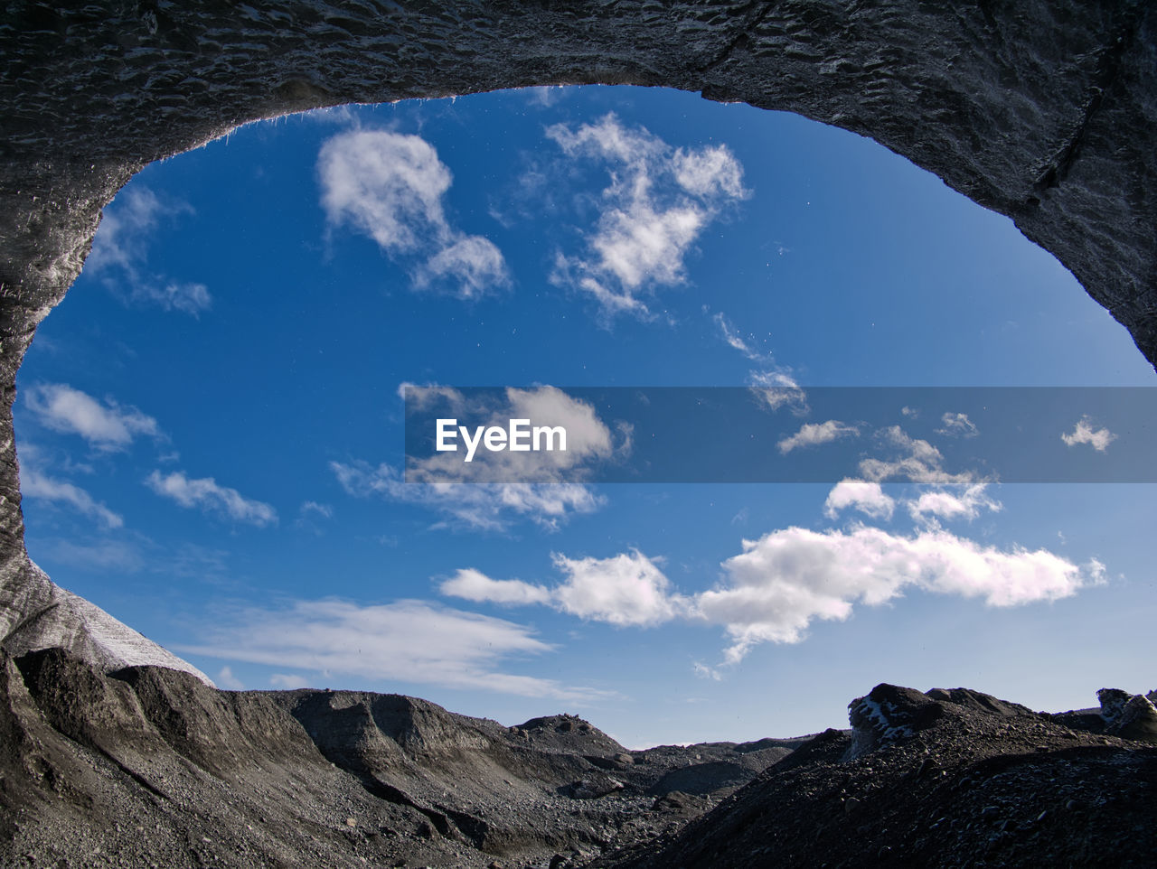 Low angle view of mountains against blue sky