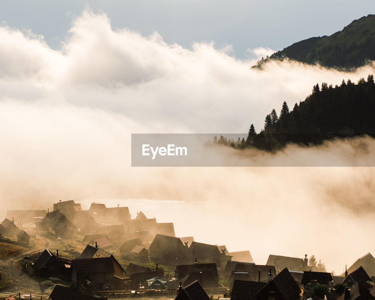 Panoramic view of buildings in mountains against sky