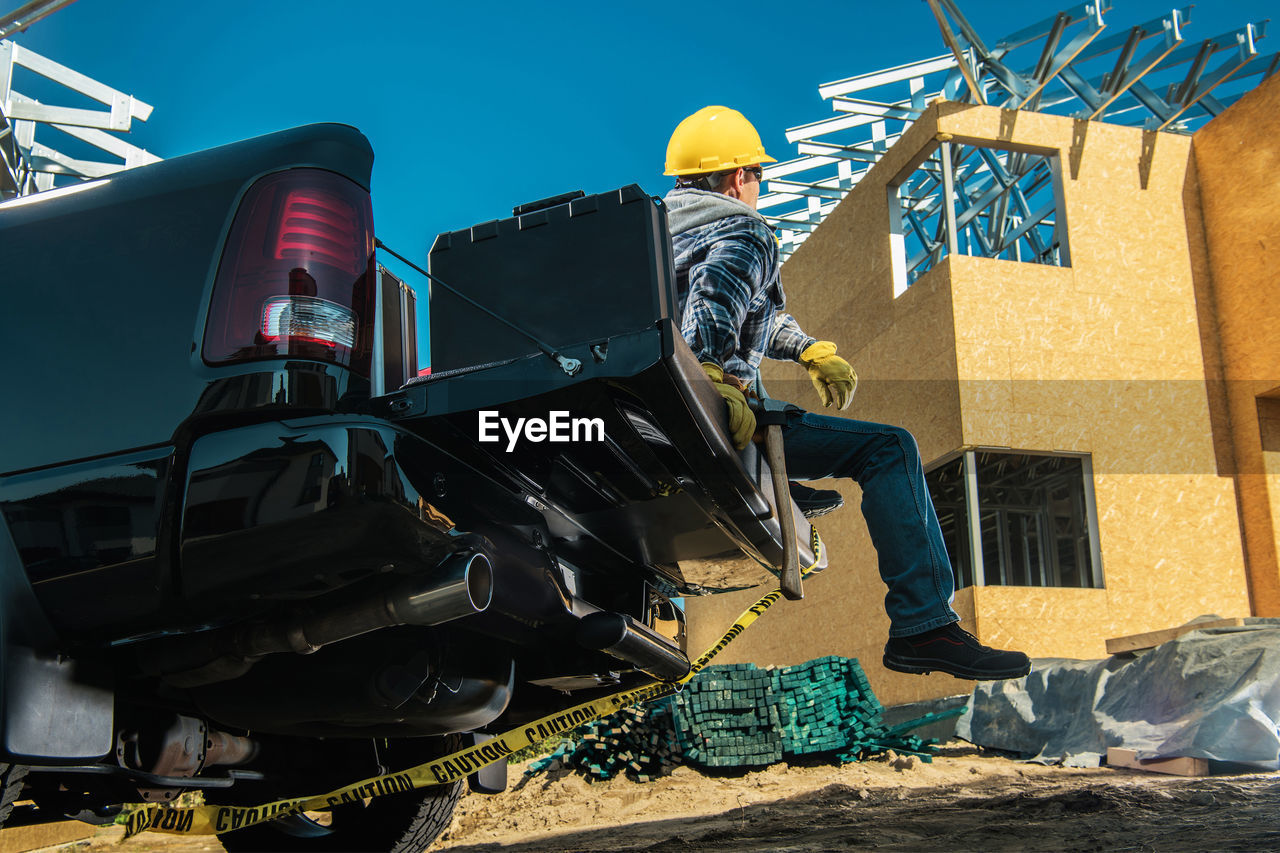 low angle view of man standing in front of building