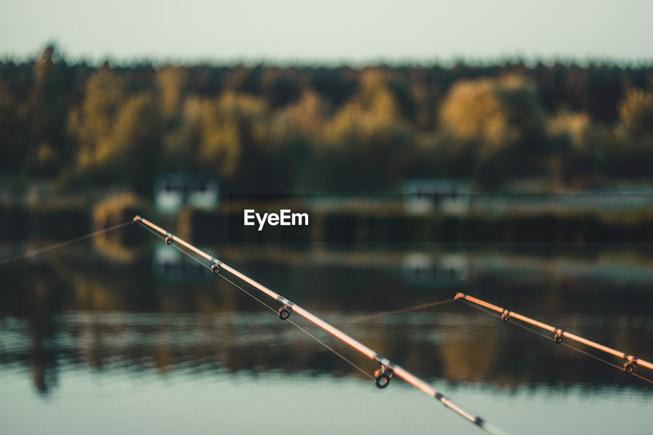 Close-up of fishing rod on lake