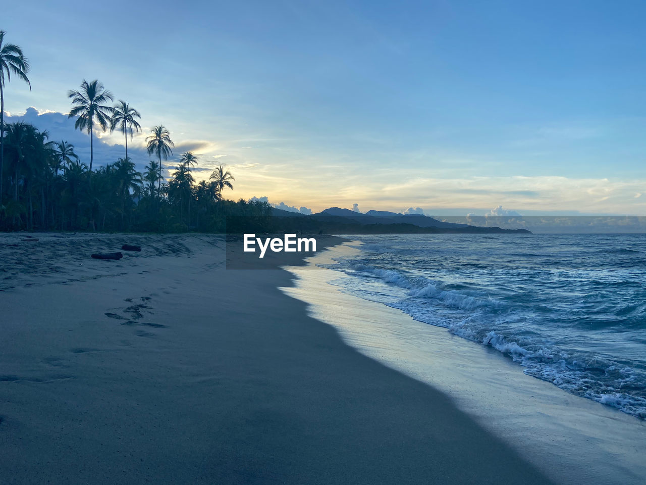 Scenic view of sea against sky at sunset