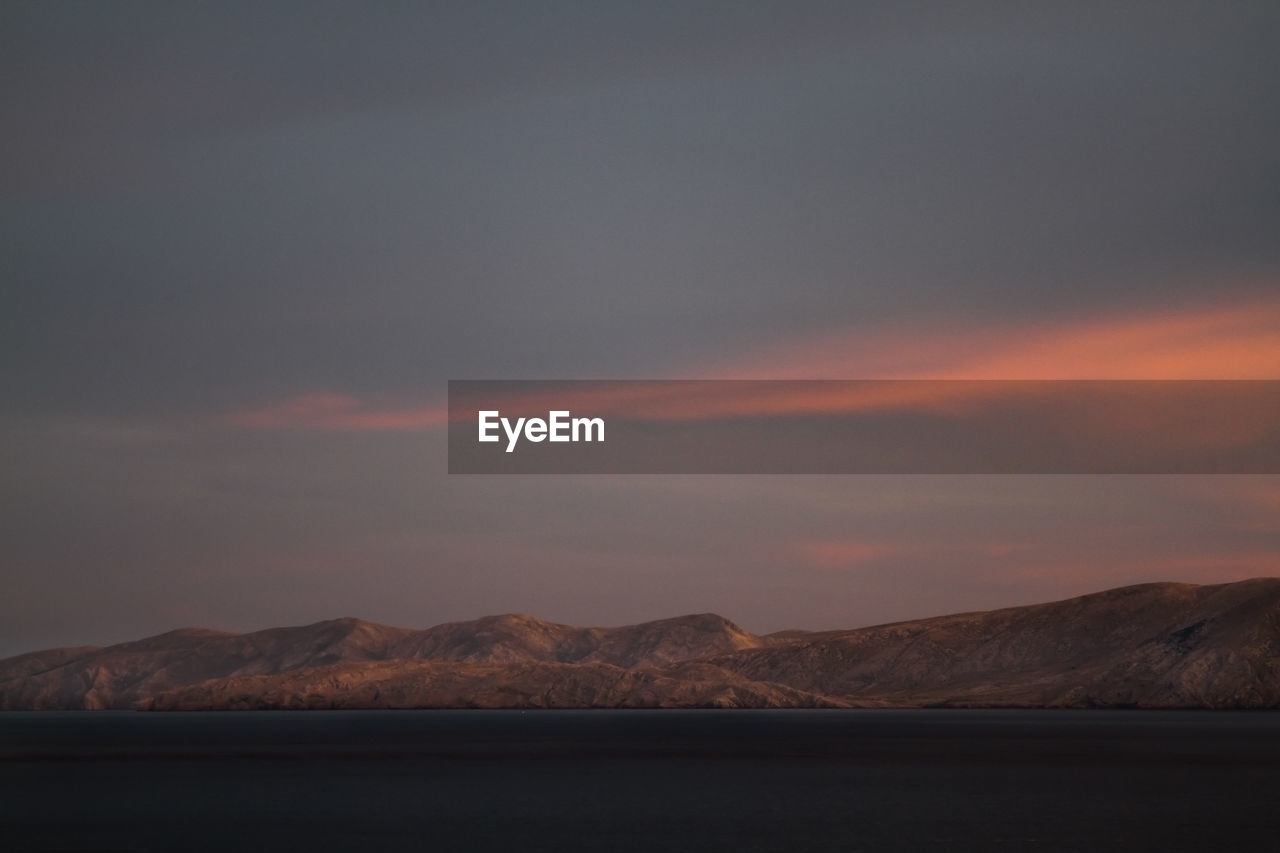 Scenic view of mountains against sky at sunset