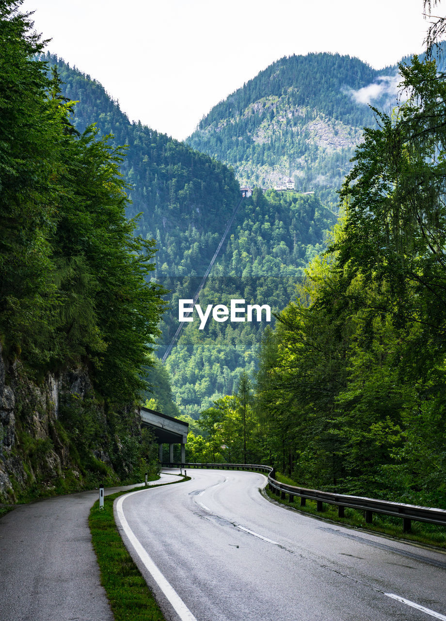 Road amidst mountains against sky