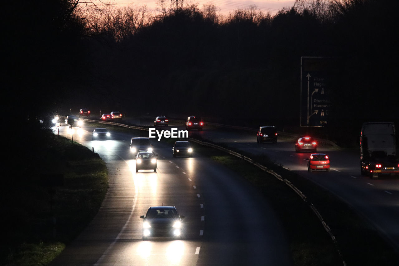 VEHICLES ON ROAD AT NIGHT