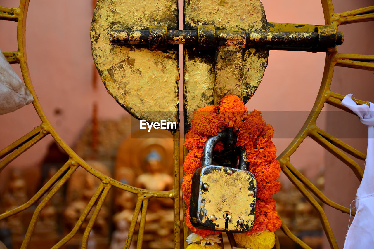 The key was attached to the gold leaf on the iron door and the garland of gaya, india.