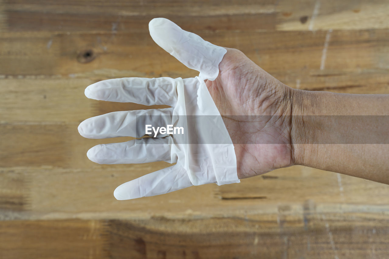 HIGH ANGLE VIEW OF MAN HAND HOLDING UMBRELLA