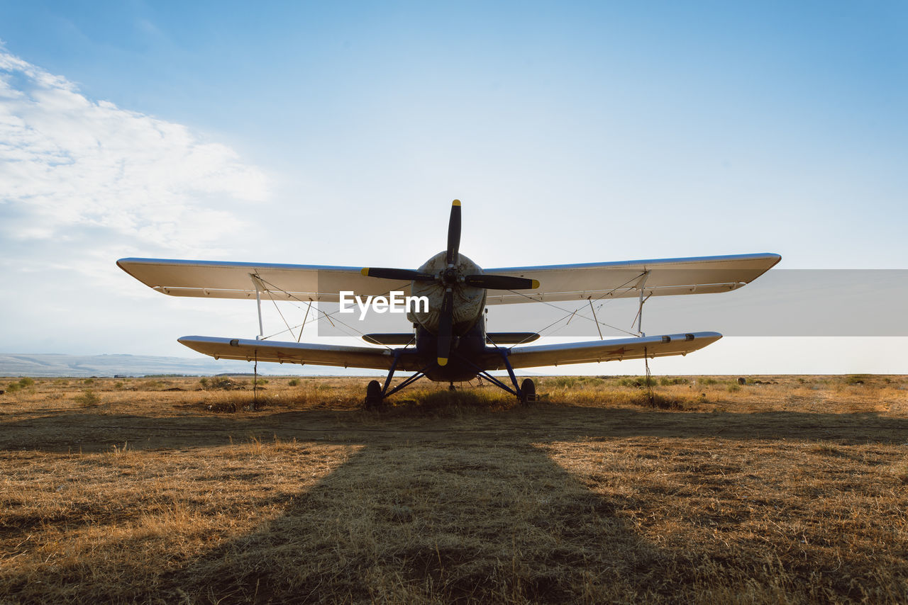 Low angle view of airplane on field against sky