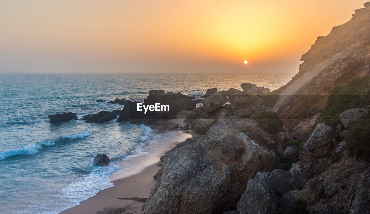 Scenic view of sea against clear sky during sunset