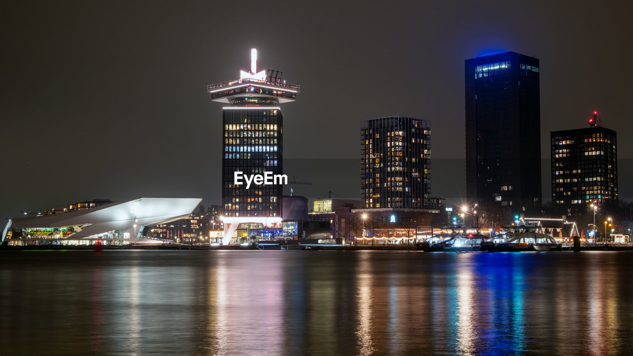 City scenic from amsterdam at the ij in the netherlands by night