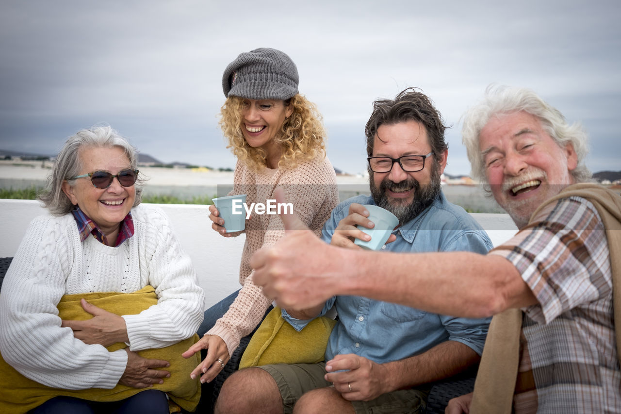 Portrait of family enjoying drink on terrace