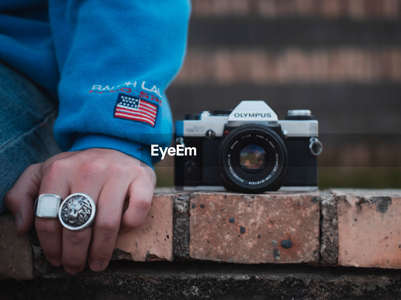 CLOSE-UP OF MAN HOLDING CAMERA